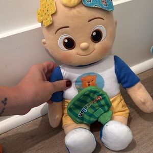 Plush COCOMELON Doll with Blue and Yellow Outfit. It sings